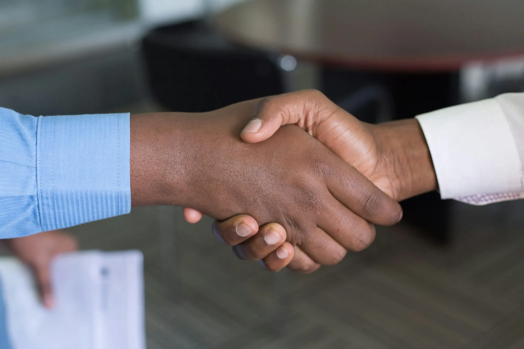 Two people shaking hands in an office